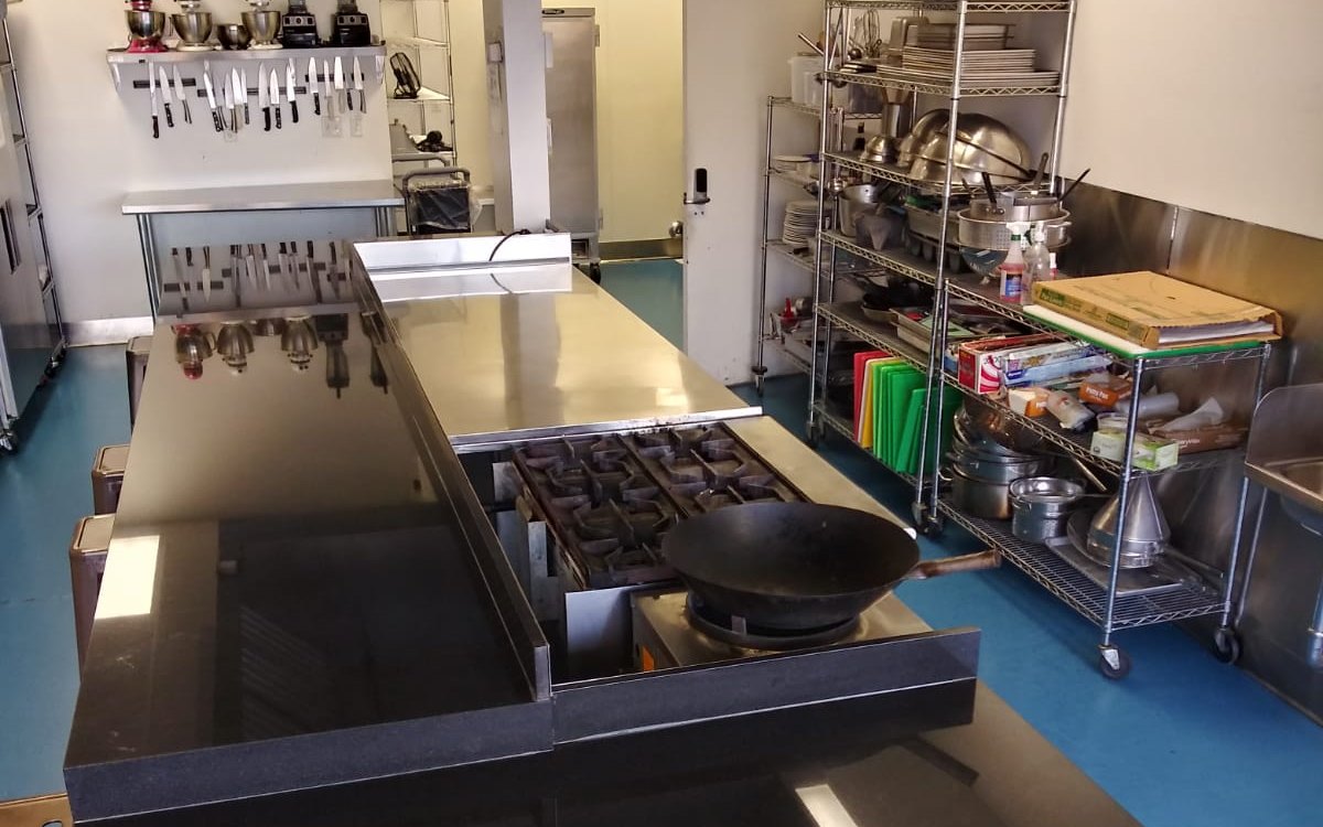 The large-format kitchen: jet-burner wok station and granite prep counter